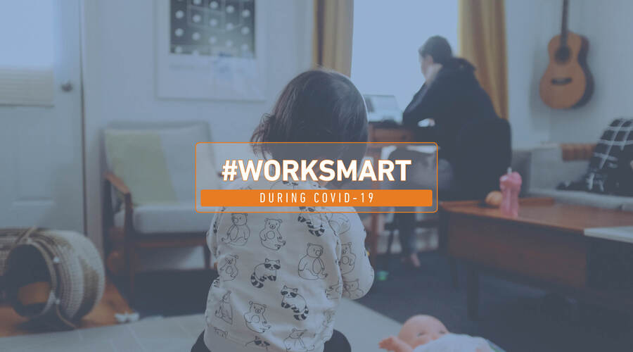 backdrop of a baby playing with toys and mother using the computer